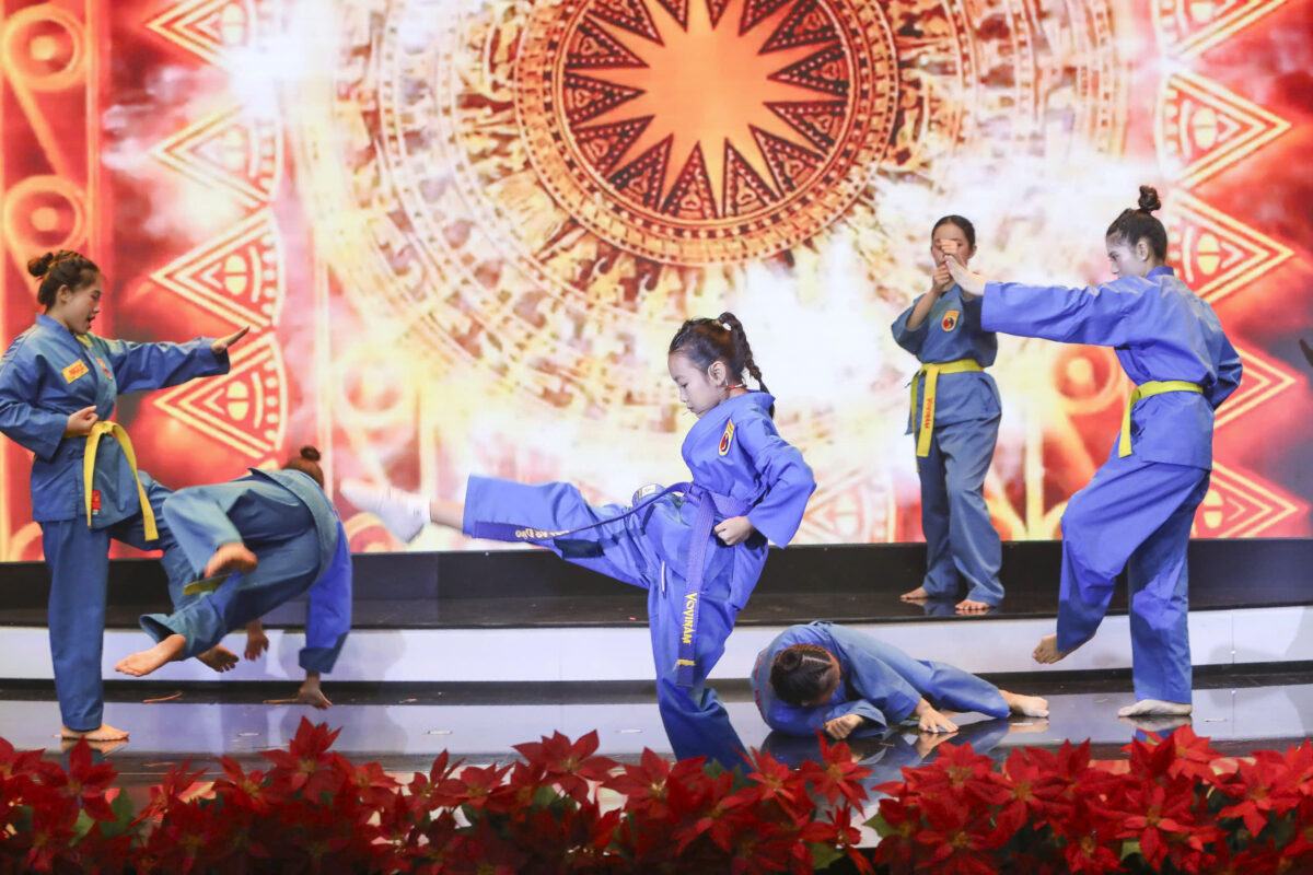 A group of children performing martial arts Description automatically generated